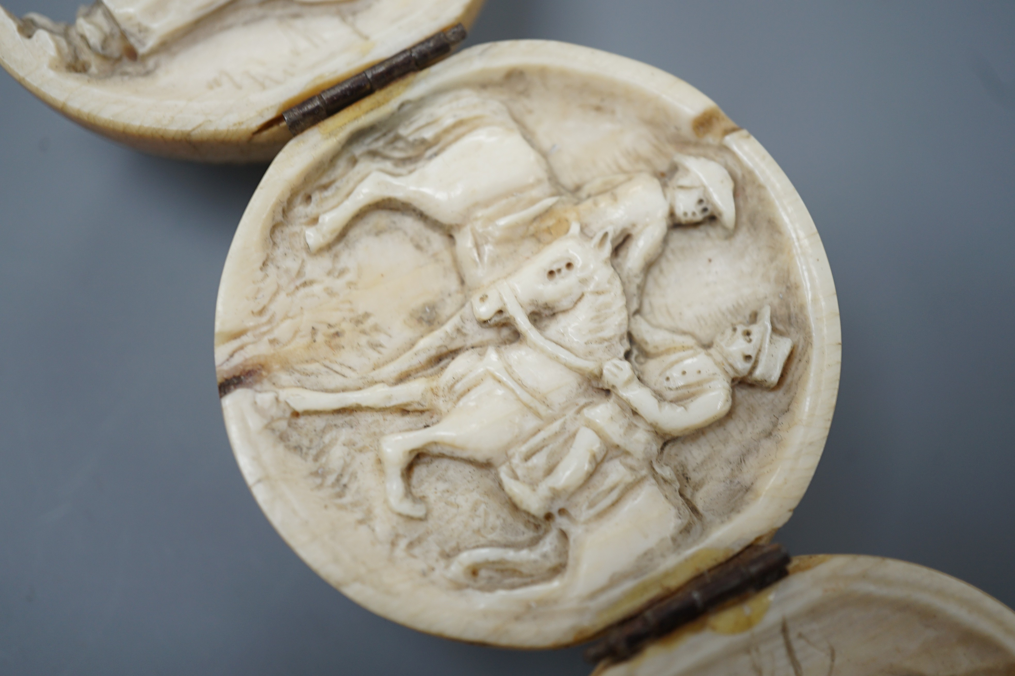 A 19th century Dieppe ivory globular triptych, possibly depicting Crimean war figures, 5.4cm diameter closed